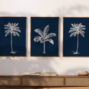 Palm tree silhouettes against blueprint background make a striking set of minimalist wall art prints. Set 3 summer palms in Hamptons style.