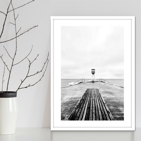 Ocean jetty beacon gritty art photography in black and white. Moody black and white ocean print depicting stormy weather. Black & White art.