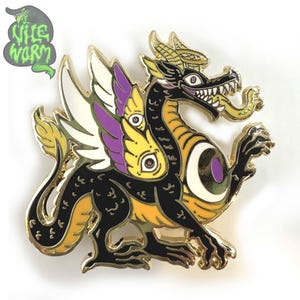 May include: A detailed enamel pin featuring a stylized dragon with multiple eyes, wings, and a serpentine body. The dragon is primarily black with yellow, purple, and white accents, and a gold-colored outline. The pin includes the text "Wile Worm" in a green, stylized font.