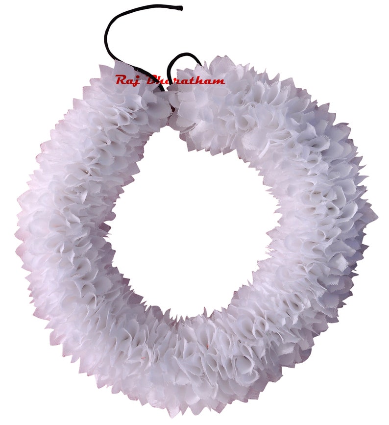 May include: White artificial flower garland, made of fabric, in the shape of a circle. The garland is tied together with a black string.