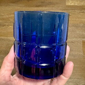 May include: A cobalt blue glass tumbler with a square patterned design.