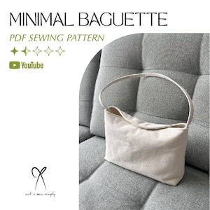 Può includere: Borsa baguette beige con manico curvo, su sfondo grigio. Visibile il testo "MINIMAL BAGUETTE PDF SEWING PATTERN", insieme a un logo YouTube e stelle.