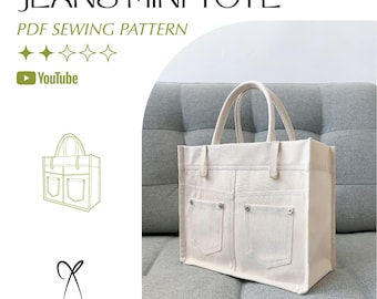 May include: A beige canvas tote bag with two front pockets, resembling jeans. The bag has two handles and is displayed on a gray sofa. Text on the image reads "JEANS MINI TOTE" and "PDF SEWING PATTERN".