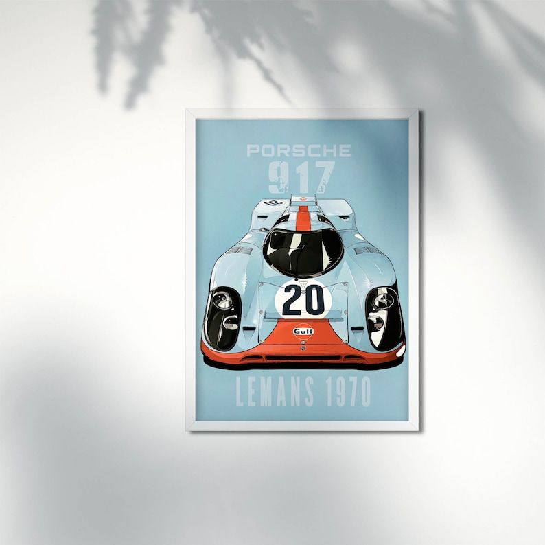 May include: A blue and white Porsche 917 race car with a red stripe and the number 20 on the front. The car has a Gulf logo on the front. The text "PORSCHE 917 LEMANS 1970" is printed below the car.