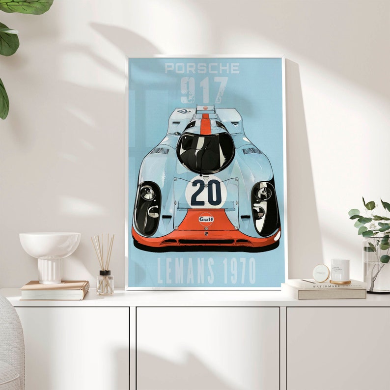 May include: A blue and white poster with a red and white race car. The car has the number 20 on the side and the word "Gulf" on the front. The poster says "Porsche 917 Le Mans 1970".