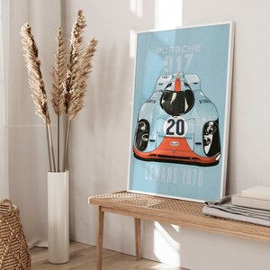 May include: A blue and white poster with a vintage race car illustration. The car is a Porsche 917 with the number 20 and the word "Gulf" on it. The poster says "Porsche 917 Le Mans 1970".