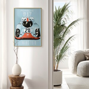 May include: A vintage poster featuring a blue and red Porsche 917 race car with the number 20 and the words "Gulf" and "Le Mans 1970".