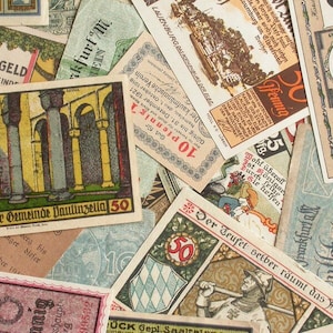 May include: A collection of vintage German paper money, featuring various denominations and designs. The money is printed on thin paper with intricate details and illustrations. Some of the bills feature text in German, including "Notgeld" and "Der Teufel selber räumt das Feld".