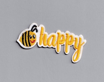 Pequeño parche termoadhesivo con el mensaje "Bee Happy" bordado con mensaje de felicidad positiva