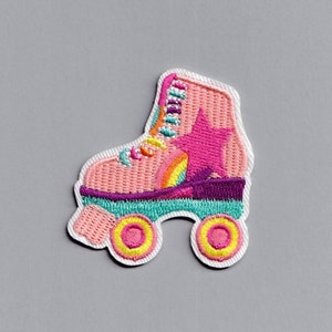May include: Pink and white embroidered patch of a roller skate with a rainbow and star design.
