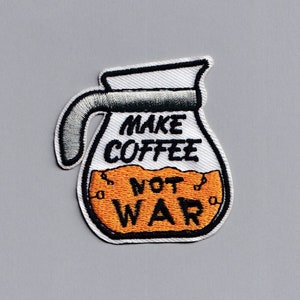 May include: White and orange embroidered patch of a coffee pot with the text "Make Coffee Not War".