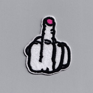 May include: White embroidered patch of a middle finger with a pink fingernail. The finger is outlined in black.