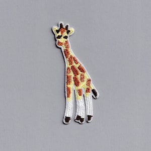 May include: An embroidered iron-on patch of a giraffe with brown and yellow spots on a white background.