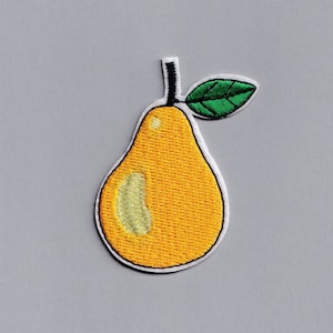May include: A yellow pear with a green leaf embroidered on a white background.