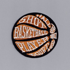 May include: A black and orange embroidered patch shaped like a basketball with the words "I'm a good shot basketball player" written around the outside.