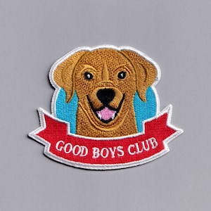 May include: White embroidered patch featuring a cartoon image of a brown dog with a blue background and a red banner that reads "Good Boys Club".