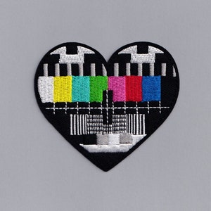 May include: Black embroidered patch in the shape of a heart with a colorful television test pattern inside.