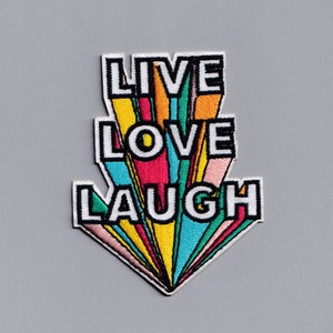 May include: A colourful embroidered patch with the words "LIVE LOVE LAUGH" in a rainbow-like design.