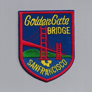 May include: An embroidered patch featuring the words "Golden Gate Bridge San Francisco" and an image of the Golden Gate Bridge, in red, white and blue.