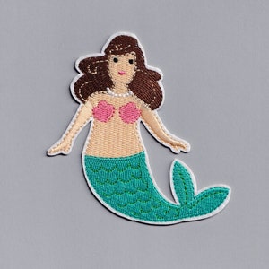 May include: Embroidered iron-on patch of a mermaid with brown hair, a pink seashell bra, and a teal green tail.