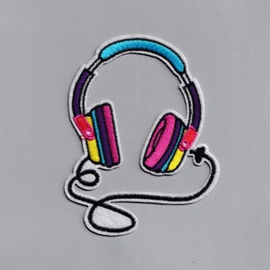 May include: An embroidered patch depicting a pair of headphones with a blue headband, pink and yellow earcups, and a black cord.
