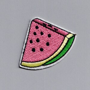 May include: A pink and green embroidered watermelon slice patch.
