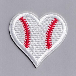 May include: White felt heart-shaped patch with red embroidered baseball stitching.