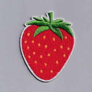 May include: An embroidered strawberry patch with red fruit, green leaves and yellow seeds. The strawberry is on a white background.