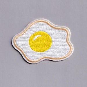 May include: A set of three ceramic mugs with a speckled, matte finish. The mugs are in shades of cream, light gray, and dark gray. Each mug has a simple, minimalist design, perfect for coffee or tea.