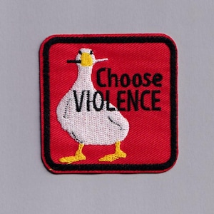 May include: Embroidered patch with a red background and a black border. The patch features a white goose with yellow feet and beak, holding a cigarette. The text "Choose VIOLENCE" is above and to the right of the goose.