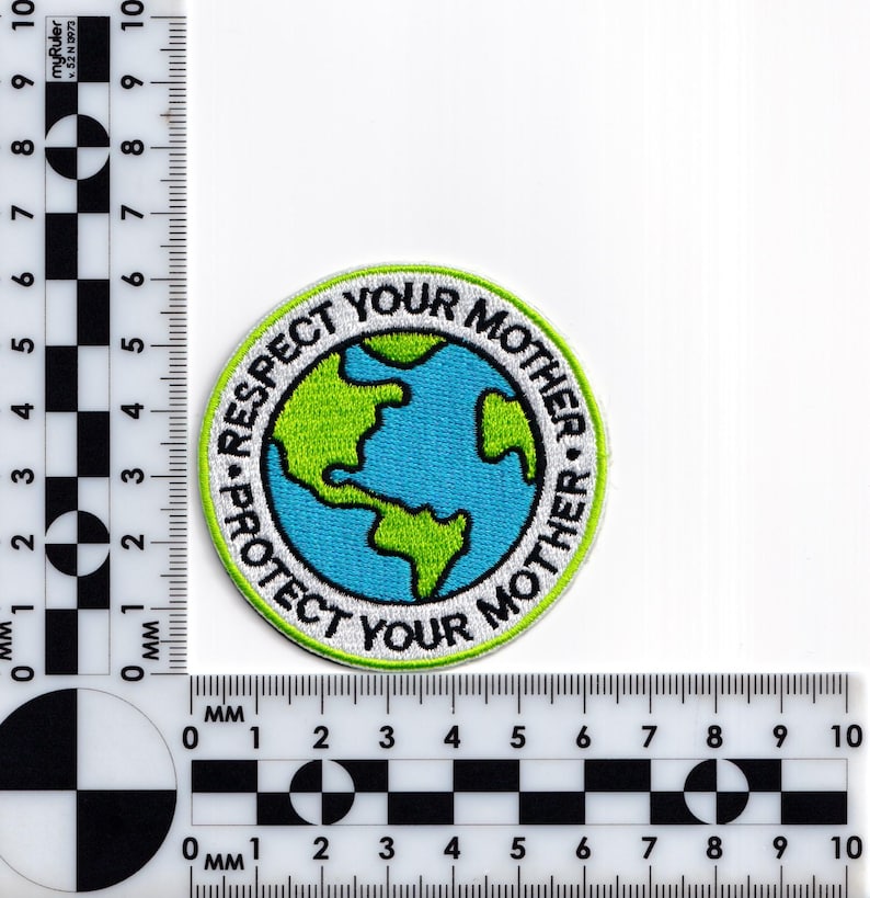 May include: A white, green and blue embroidered patch with a globe in the centre and the text "Respect Your Mother * Protect Your Mother" around the globe.