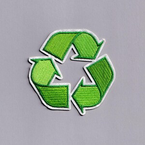 May include: Embroidered green recycling symbol patch with a white border. The patch features the classic three-arrow design, symbolizing reduce, reuse, and recycle. The patch is on a gray background.