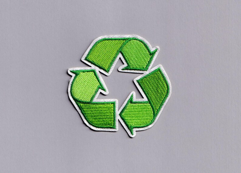 May include: Embroidered green recycling symbol patch with a white border. The patch features the classic three-arrow design, symbolizing reduce, reuse, and recycle. The patch is on a gray background.