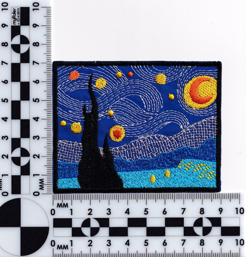 May include: Embroidered patch featuring a rendition of Vincent van Gogh's 'Starry Night' painting. The patch depicts a swirling night sky with a bright yellow moon and stars, a dark cypress tree, and a village in the distance. The colors are vibrant and the details are intricate.