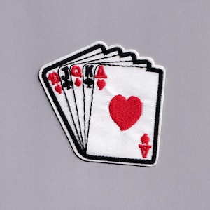 May include: Embroidered patch featuring a hand of playing cards. The cards are white with black borders and show the 10 of hearts, Jack of spades, Queen of hearts, King of clubs, and Ace of hearts. The patch is on a gray background.