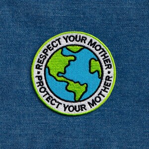 May include: A white, green and blue embroidered patch with the text "Protect Your Mother - Respect Your Mother" surrounding a blue and green globe.