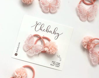 Coleteros con pompones de mariposa: Juego de 2 para bebés y niños pequeños