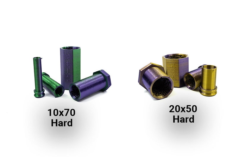 May include: An assortment of metallic, hexagonal-shaped objects in green, purple, and gold. The text "10x70 Hard" and "20x50 Hard" are displayed below the objects. The objects are cylindrical and have a textured surface.