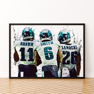 May include: Three football players wearing green and white uniforms with their numbers on the back. The players are standing close together and the image is in a watercolor style. The numbers on the back of the jerseys are 11, 6, and 26. The text on the jerseys reads "Brown", "Smith", and "Sanders".