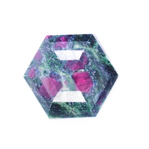 May include: A hexagonal cut gemstone with a green and pink marbled pattern. The gemstone is faceted and has a clear, glassy appearance.