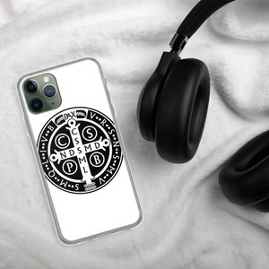 May include: A clear phone case with a black and white image of the Miraculous Medal. The medal features a cross with the letters 'C.S.S.M.D.  N.D.S.M.D.  P.M.L.  B.V.M.' around it. The words 'V.R.S.N.S.M.O.V.B.P.A.X' are around the outside of the medal.