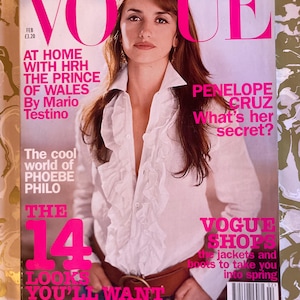 May include: A Vogue magazine cover with Penelope Cruz wearing a white ruffled shirt and a brown belt. The magazine title is in pink. Text includes "What's her secret?" and "The 14 looks you'll want". The price is £3.20.