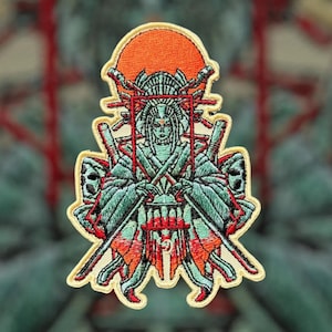 May include: Embroidered patch featuring a woman in a traditional Japanese outfit holding a lantern. The woman is surrounded by a red and orange sun and two swords. The patch is outlined in yellow.