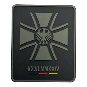 May include: Black and grey patch with a German eagle and cross. The text "VX.VI.MMXXIV" is below the eagle and cross. The German flag is below the text.
