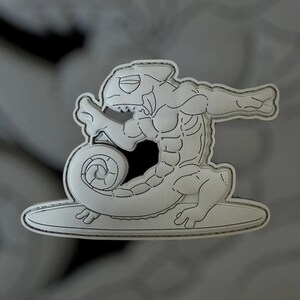 May include: A white, stylized illustration of a muscular chameleon surfing on a surfboard. The chameleon has a detailed outline with shading, giving it a three-dimensional appearance. The surfboard is also white with a black outline.