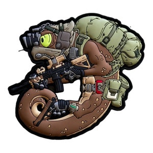 May include: A detailed patch featuring a cartoonish reptile soldier in combat gear. The design includes a rifle, night vision goggles, and a backpack, with a color palette of brown, tan, green, and black. The patch has a black border.