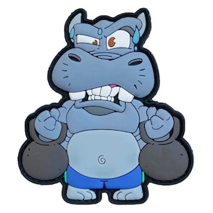 May include: A cartoon patch showing a grey hippo lifting two dark grey kettlebells. The hippo has an angry expression, sweat droplets, and is wearing blue shorts. The patch has a black border.