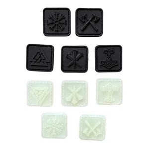 May include: A collection of ten square patches featuring Norse-inspired symbols. Five patches are solid black, and five are a pale, off-white color. The designs include a Vegvisir, crossed axes, a Valknut, a spear bundle, and Mjolnir.
