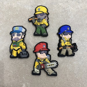 May include: Four cartoon-style patches featuring firefighters in yellow uniforms and helmets. Each patch depicts a firefighter with different tools, including an axe, chainsaw, and hammer. The patches have a black border and are set against a neutral background.