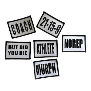 Puede incluir: Seis parches blancos con texto negro. Los parches dicen "Coach", "21-15-9", "But Did You Die", "Athlete", "NoRep", y "Murph".